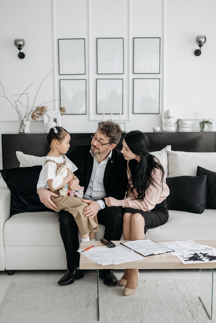 services-03 Family enjoying a moment of togetherness in a stylish indoor living room, symbolizing love and connection.